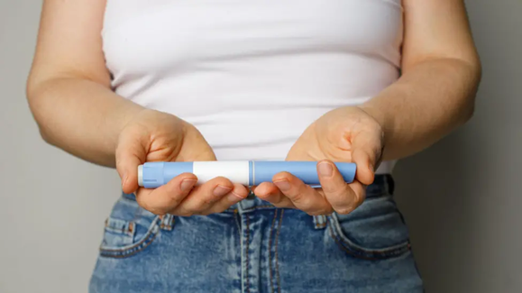 woman holding weight-loss drug kit